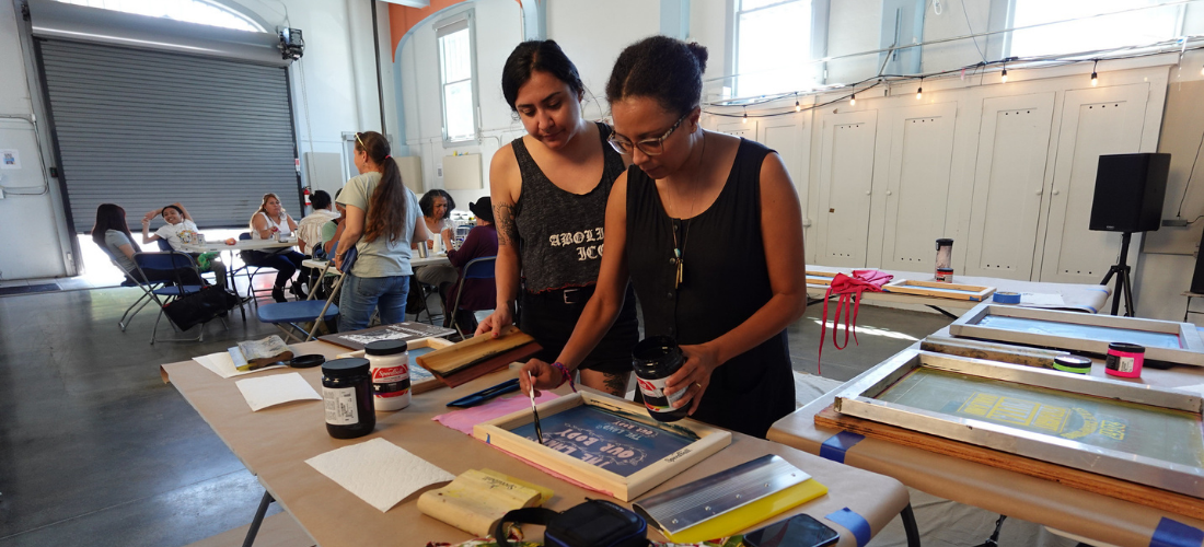 Law Center staff screen printing at one of our community parties