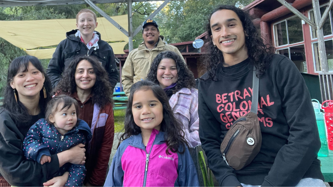 Law Center team and family at Shelterwood - standing and kneeling next to a building