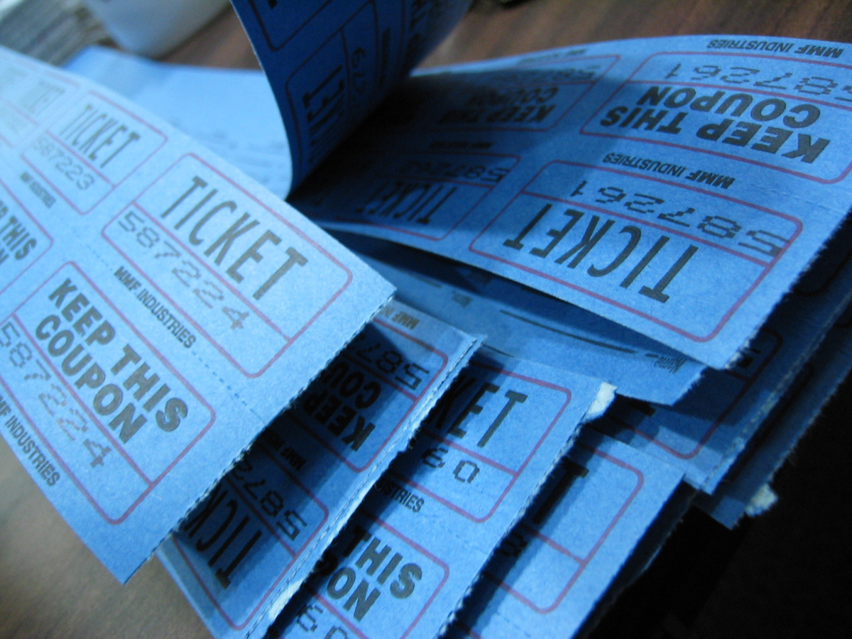 A picture of teal raffle tickets with black writing