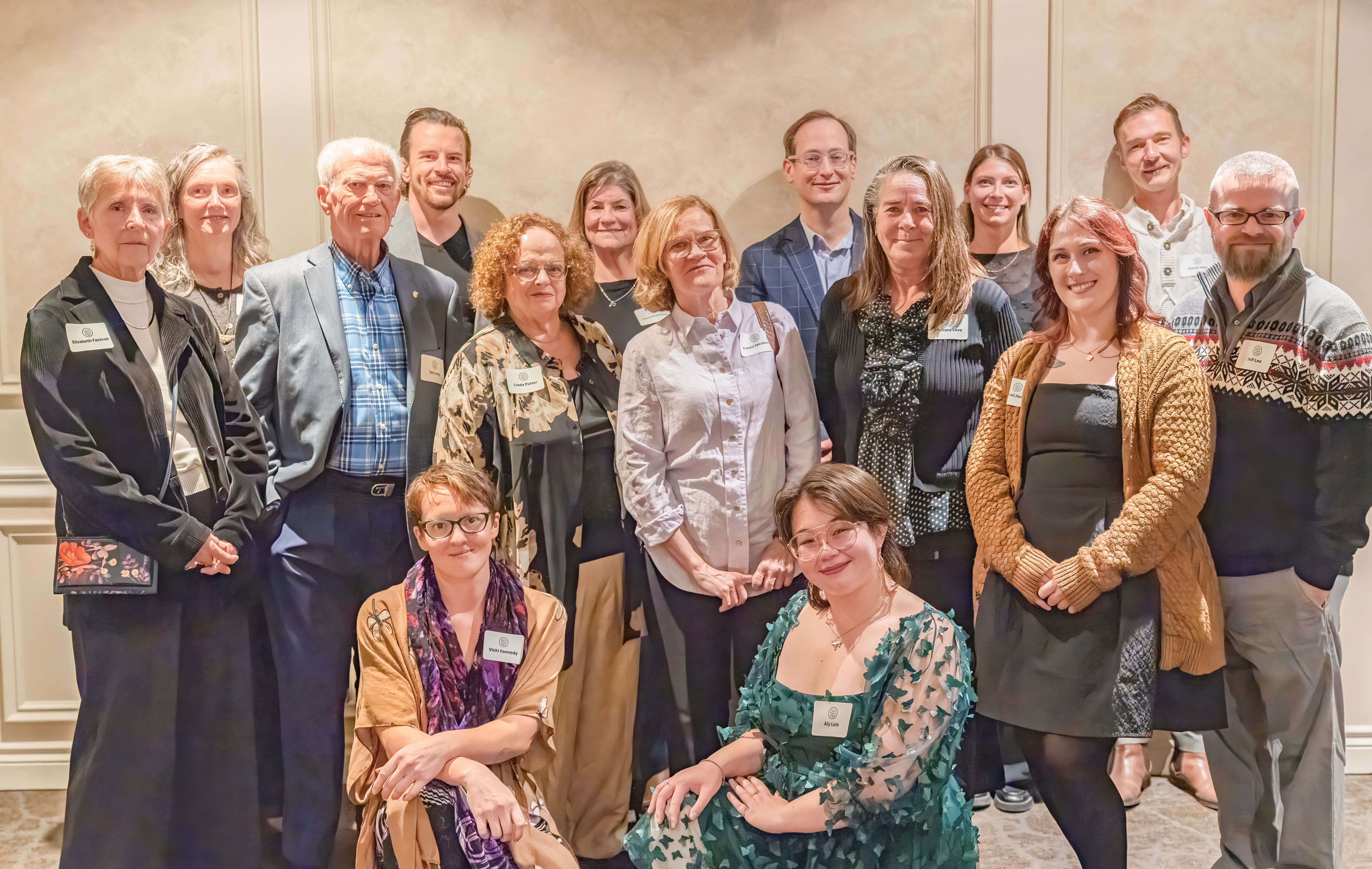 A large group of 15 people posing for a photo