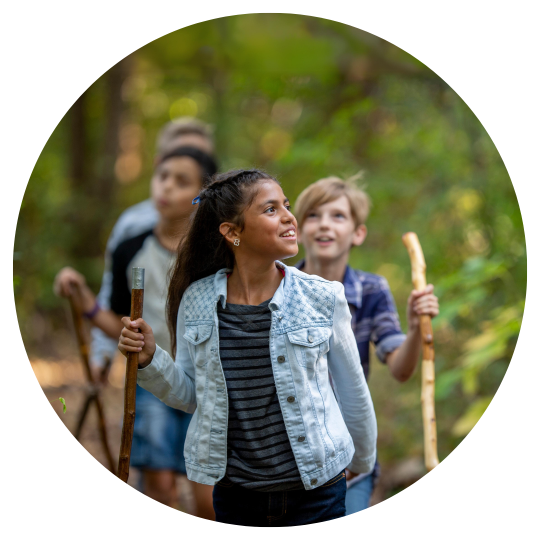 Girl hiking through forest with friends.