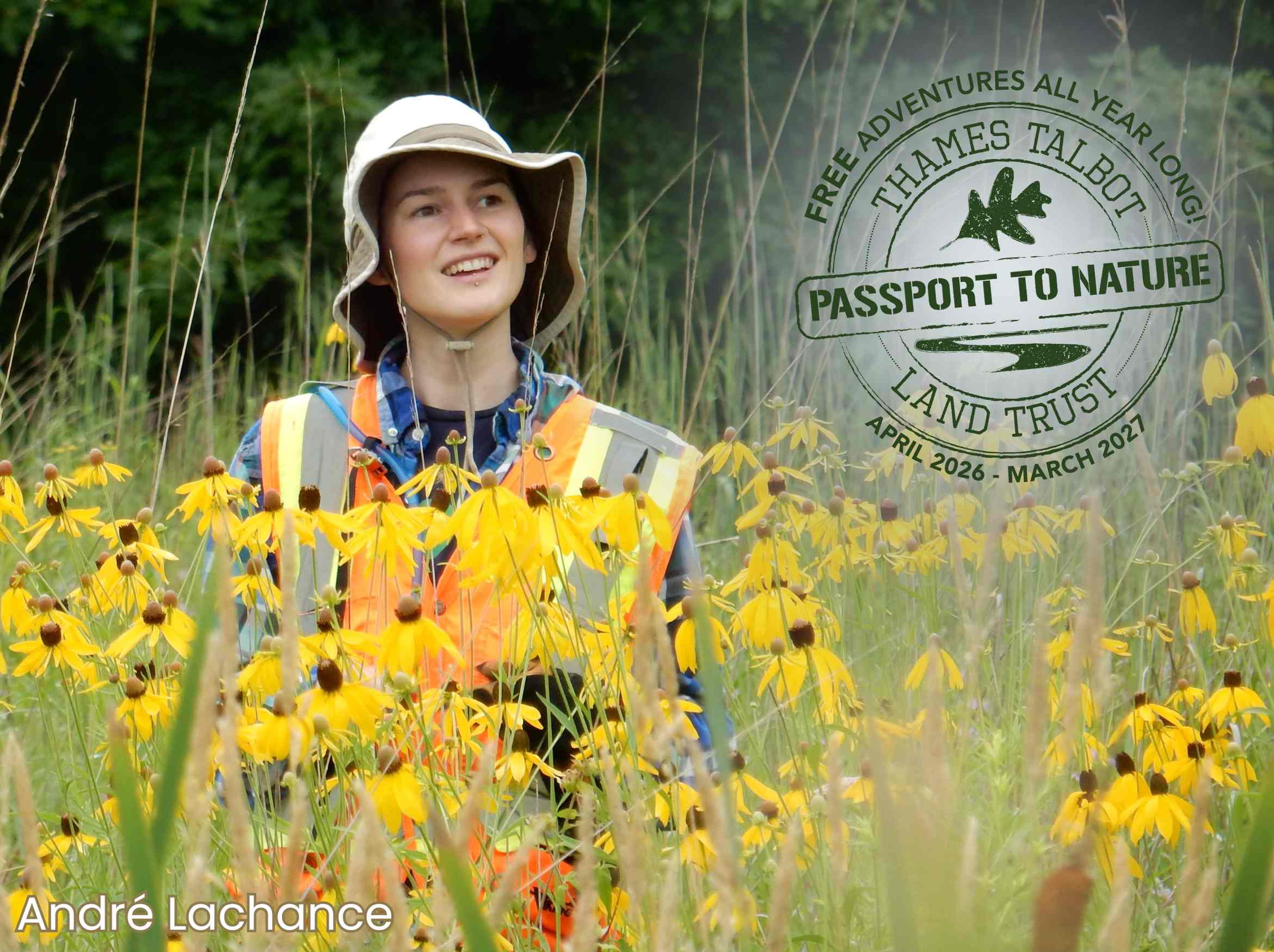 Payton Landsborough in a sun hat and high-vis vest standing in meadow of tall grey headed cone flowers