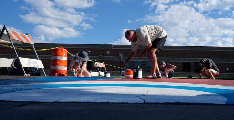 (Leah Hogsten | The Salt Lake Tribune) From left, Kelbe Goupil, Turner Bitton, Kyle Goupil and Tessa Cramer paint the asphalt on Emery Street at the crosswalk in front of Parkview Elementary School, Saturday, July 29, 2023.