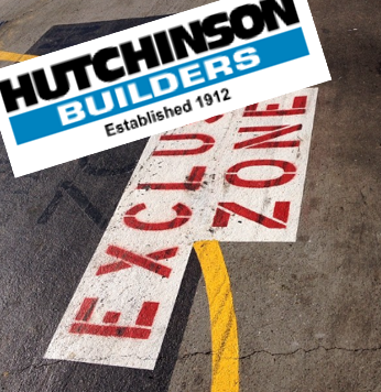 Workshop floor with the words “Exclusion Zone”. Overlaid is the logo for Hutchinson Builders.