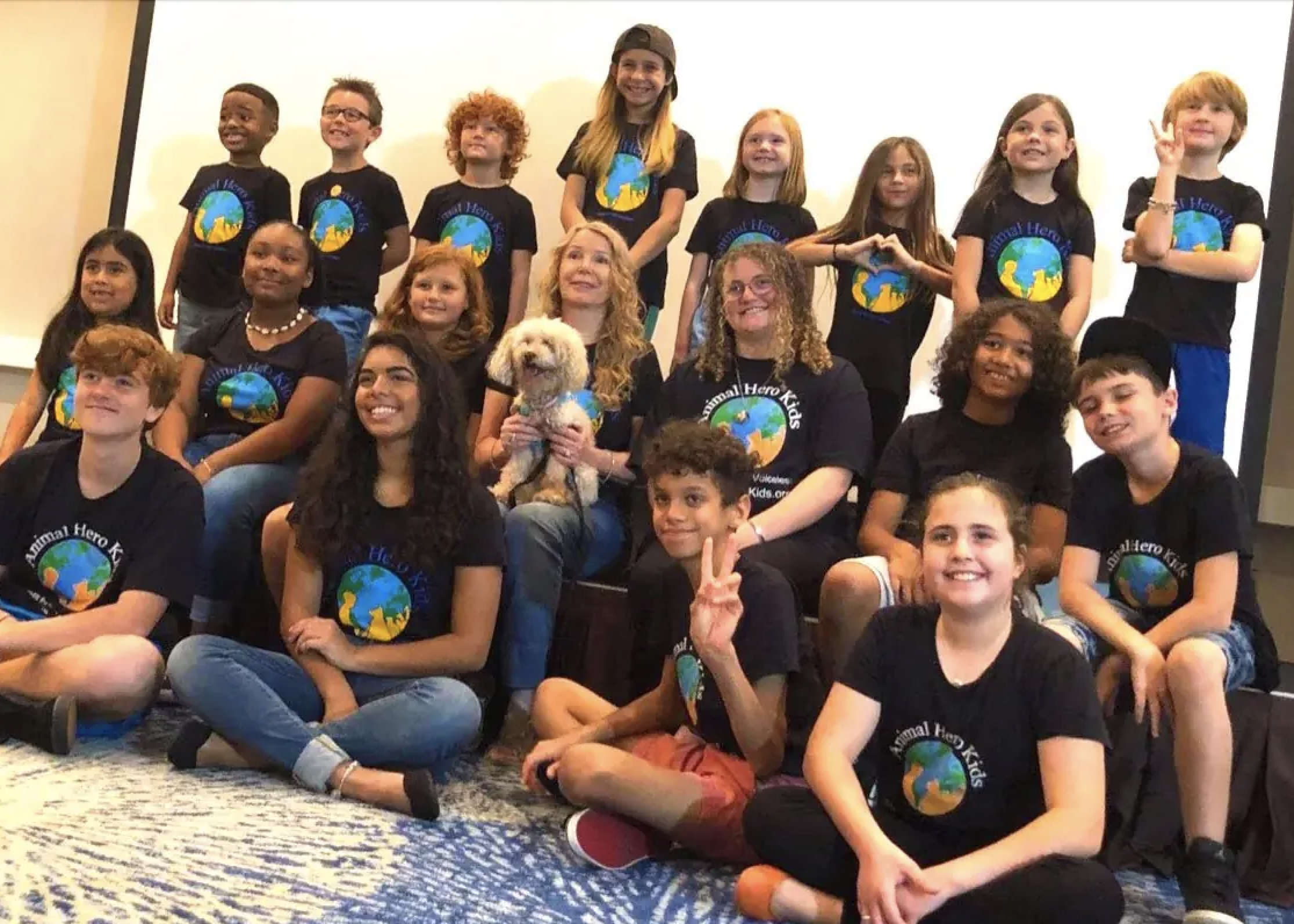 Children stand in group wearing matching Animal Hero Kids t-shirts