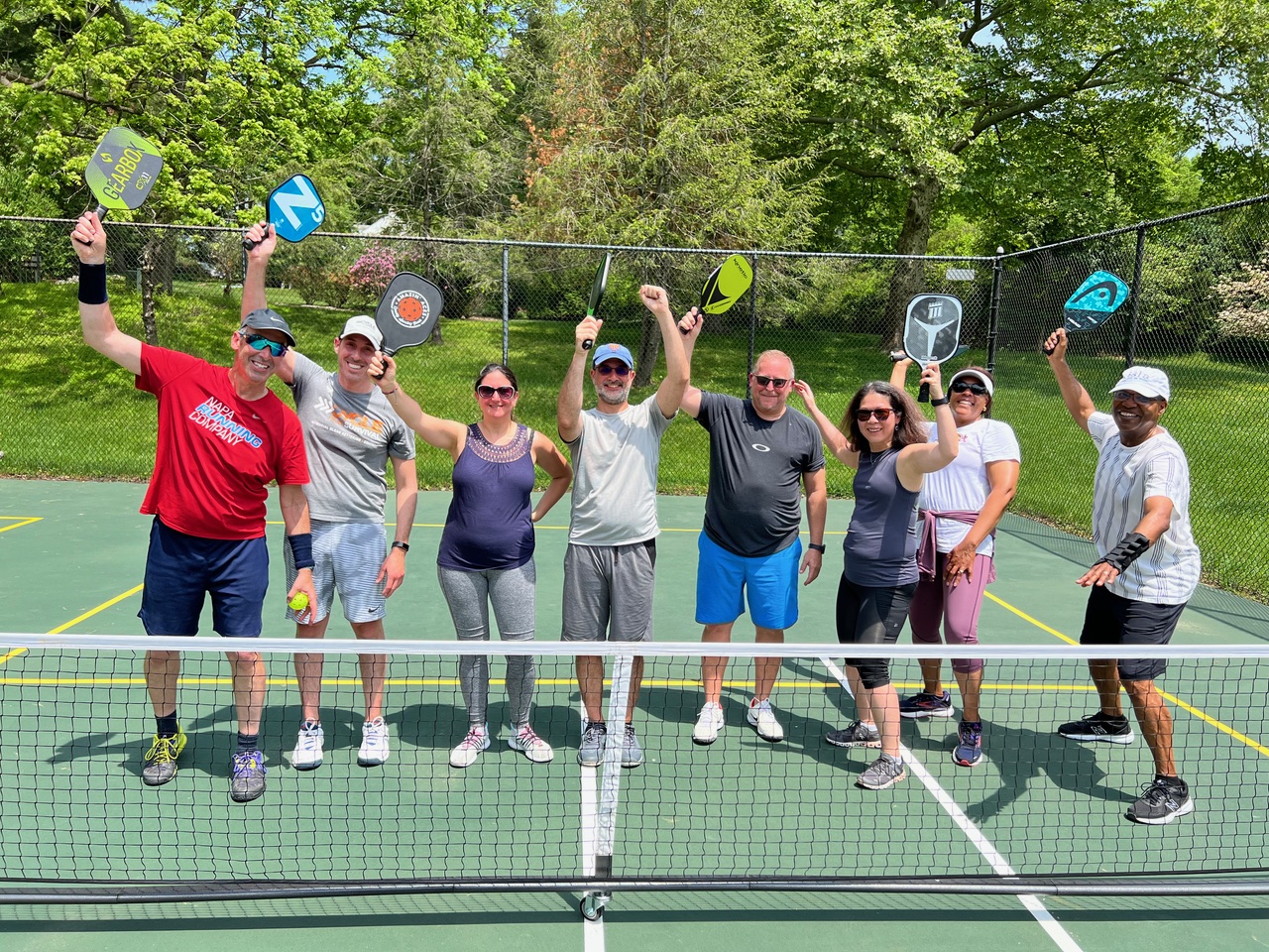 A group of people holding paddles and rackets on a tennis court

AI-generated content may be incorrect.