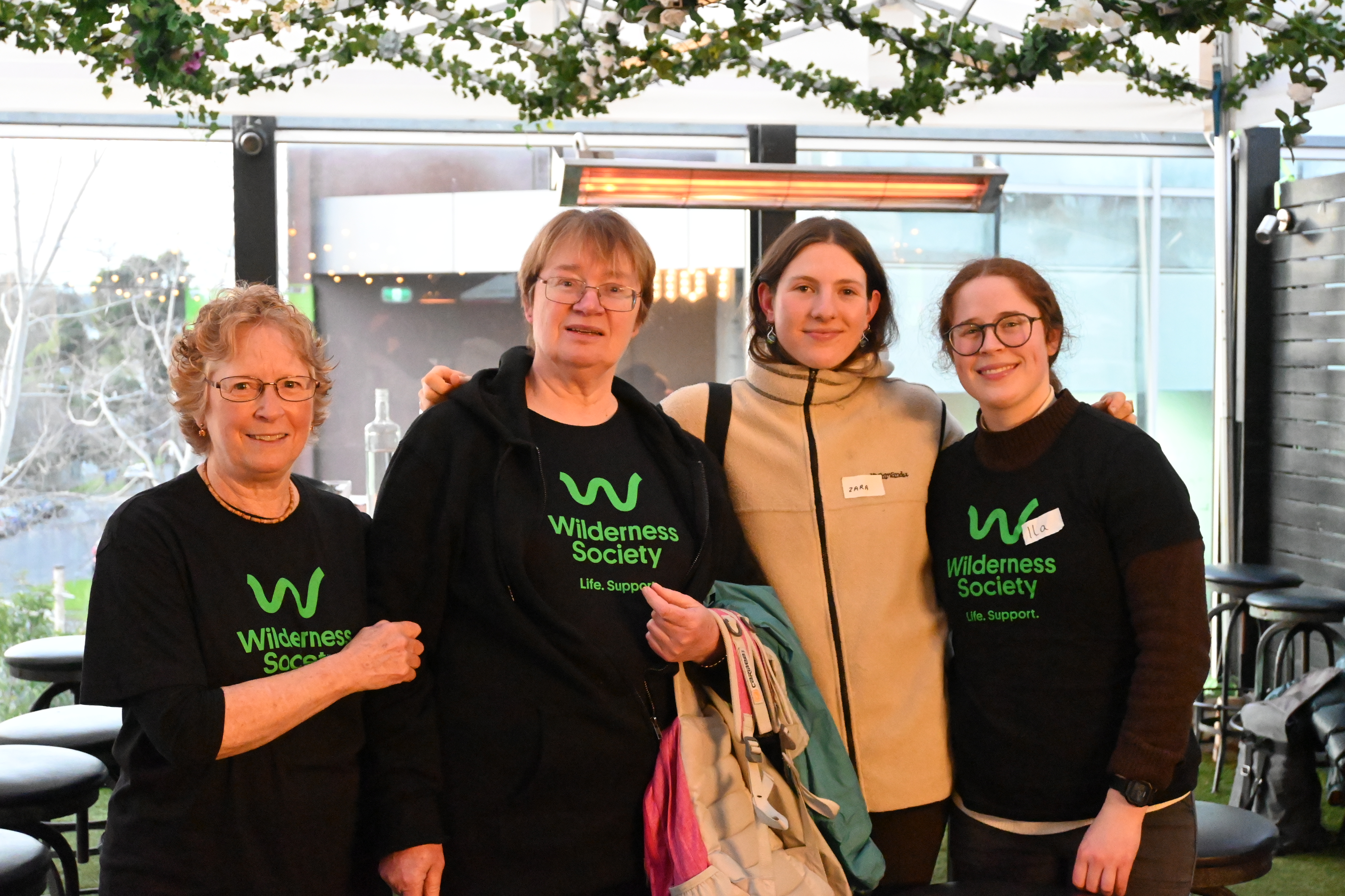 Four of the East Group members smiling at a Community Catch Up event they ran.