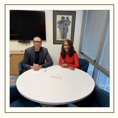 WTU President signs WTU contract with DCPS Chancellor smiling